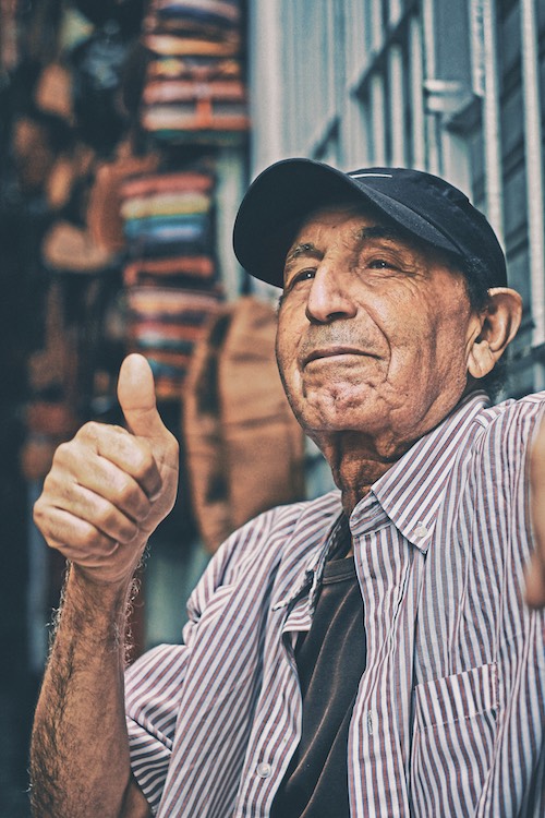 Old man giving a thumbs up because he was just approved for a loan